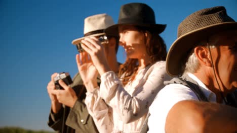 friends looking through binoculars during safari vacation 4k