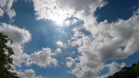 Nubes-De-Lapso-De-Tiempo-Que-Se-Mueven-Para-Revelar-La-Llamarada-Del-Sol-Con-árboles