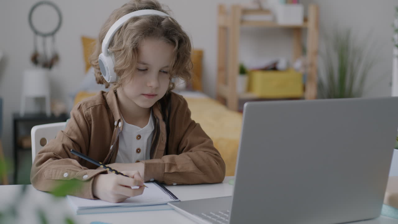 Child Doing Homework on Laptop