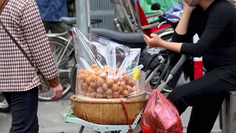 vendor selling desserts on a busy street