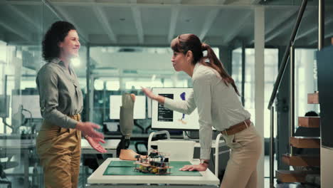 two women in an office discussing a prosthetic leg