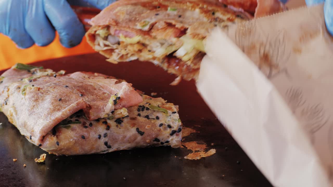 Chinese traditional street food Jianbing close-up. Cooking asian crepe Jianbing, one of China most popular street breakfasts. High quality 4k footage