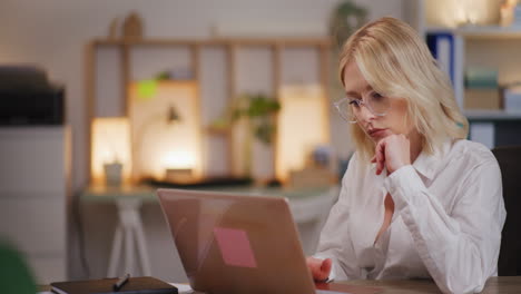 Woman-Working-on-Computer-in-Evening-and-Pondering