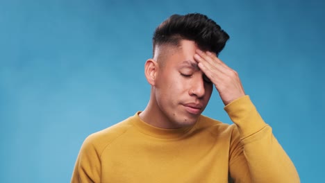 exhausted and stressed man massaging his head while suffering from headache.