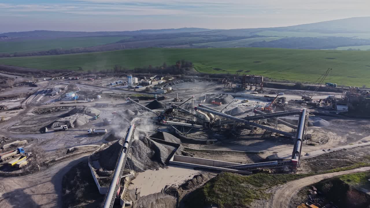 Quarry activity with heavy machinery and conveyor belts in operation