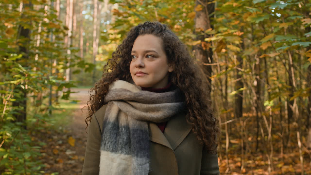 Woman with Curly Hair in Autumn Forest