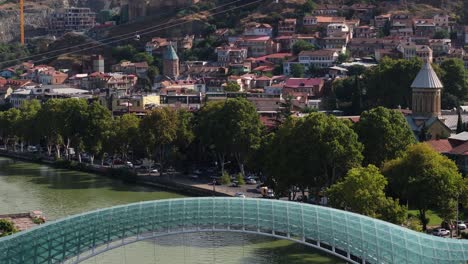 forward dolly shot above bridge of peace, tbilisi, georgia. kura river