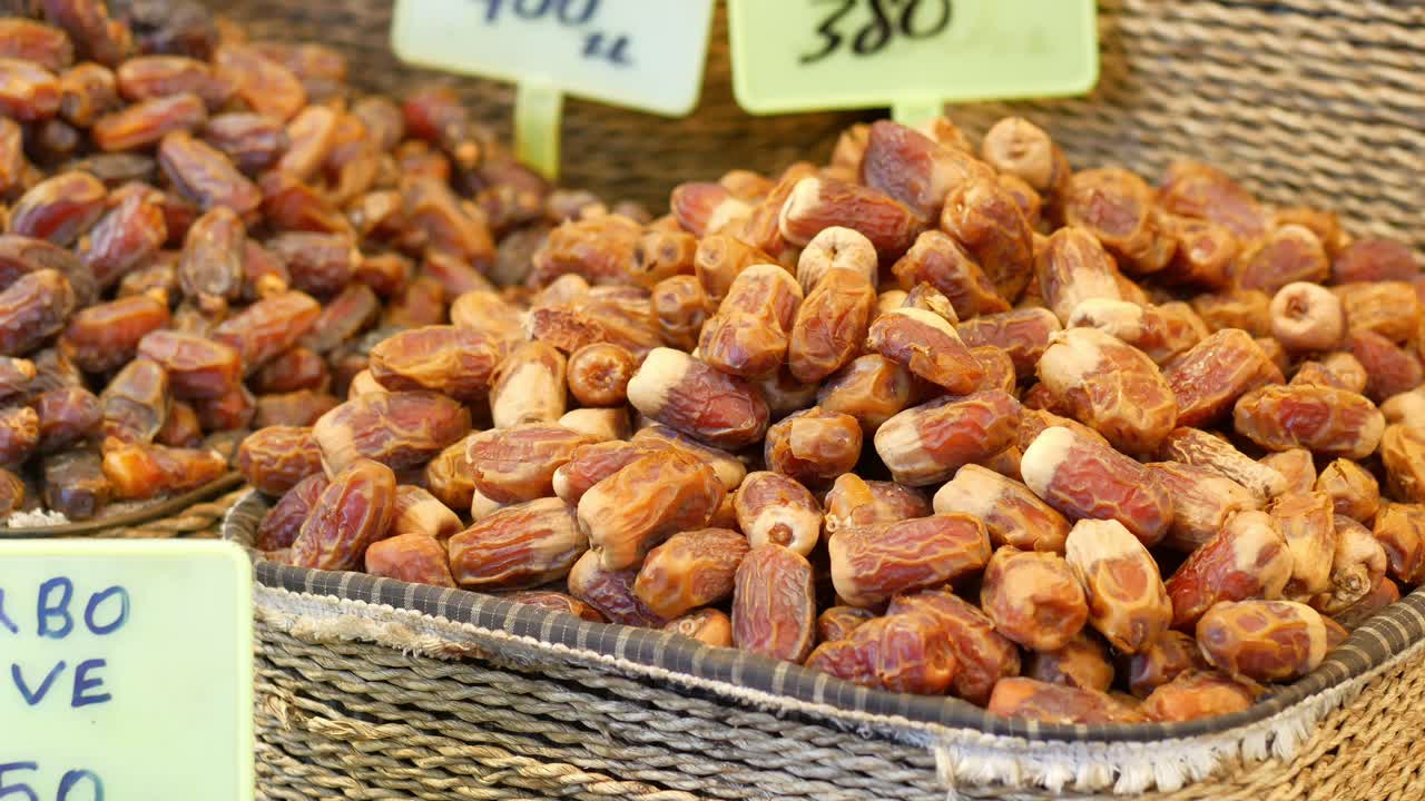Close up of a basket of dates for sale at a market