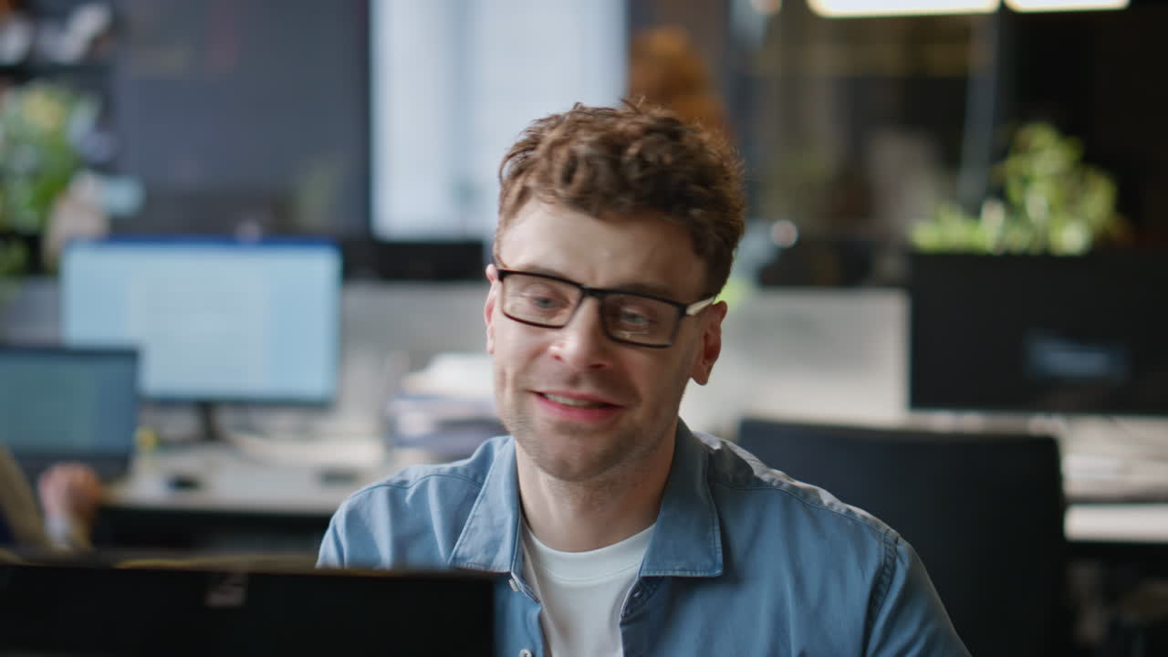 Creative manager calling video chat in modern office closeup. Man talking online
