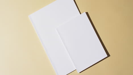 video of books with blank white pages and copy space on yellow background