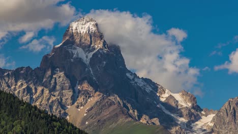 4k moving clouds time lapse over the single snow mountain peak ushba, the georgia nature alps matterhorn near the mestia ushguli and shkhara mt