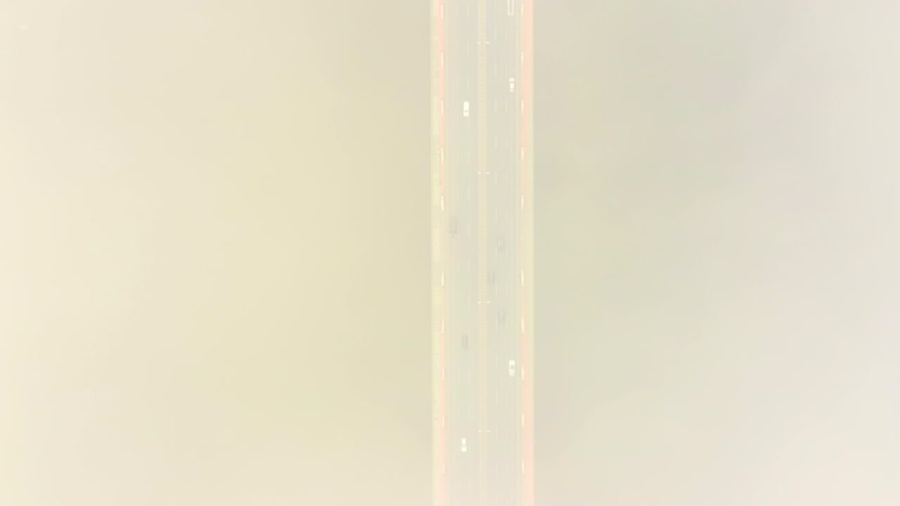 Aerial drone view. bridge in the rays of a sunny morning. Autumn haze in the air, cars are driving across the bridge. Cloudy day
