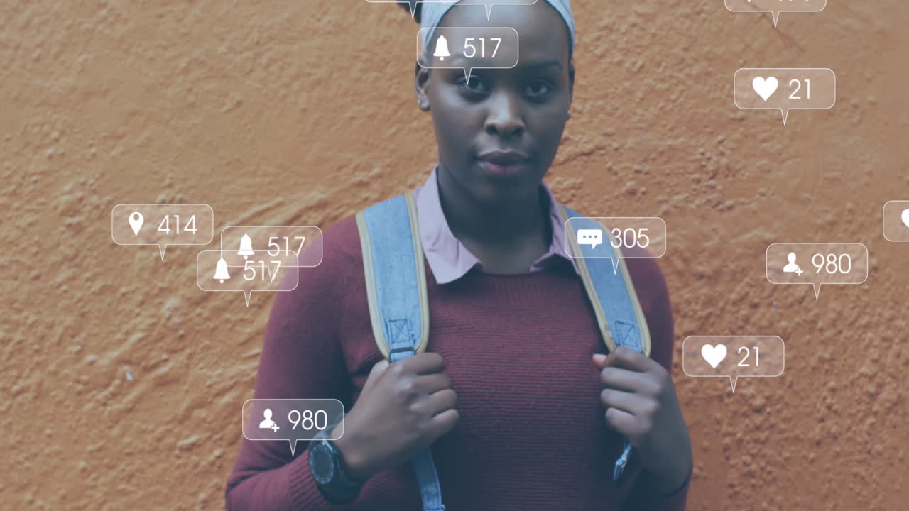 Animation of social media notifications over laughing african american woman in city street