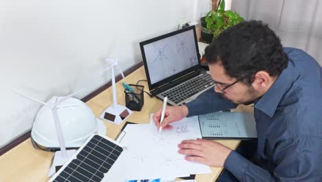 engineer cross-referencing designs for a wind energy project