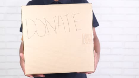 person holding a donation box