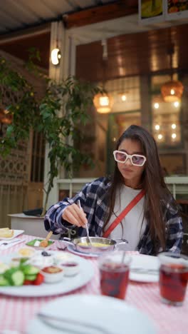 young woman enjoying a turkish breakfast outdoors