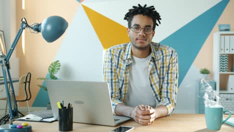 cinemagraph portrait of handsome afro-american businessman at desk in office room