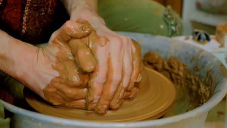 professional male potter making pot in pottery workshop