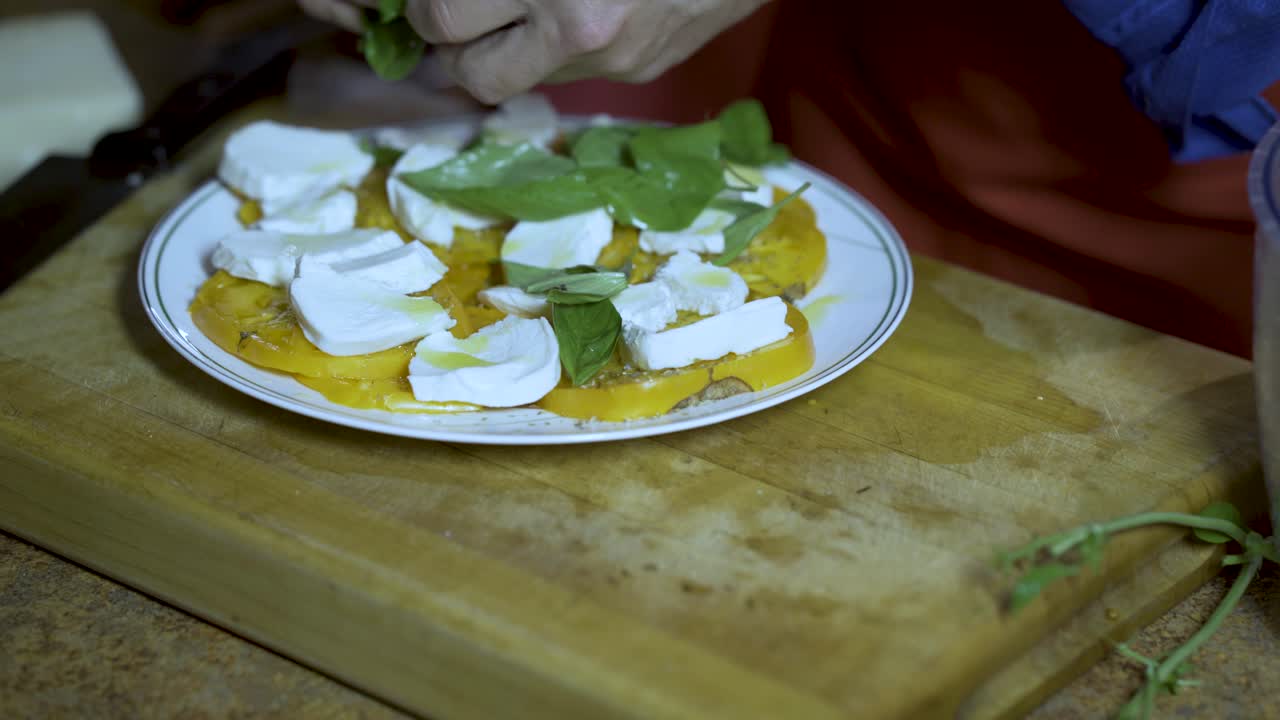 Caprese salad being prepared