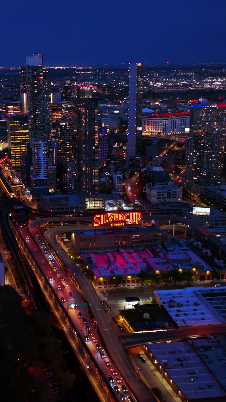 Film and television Silvercup Studios in Queens, New York. Fabulous lights of evening city from aerial perspective. Vertical video
