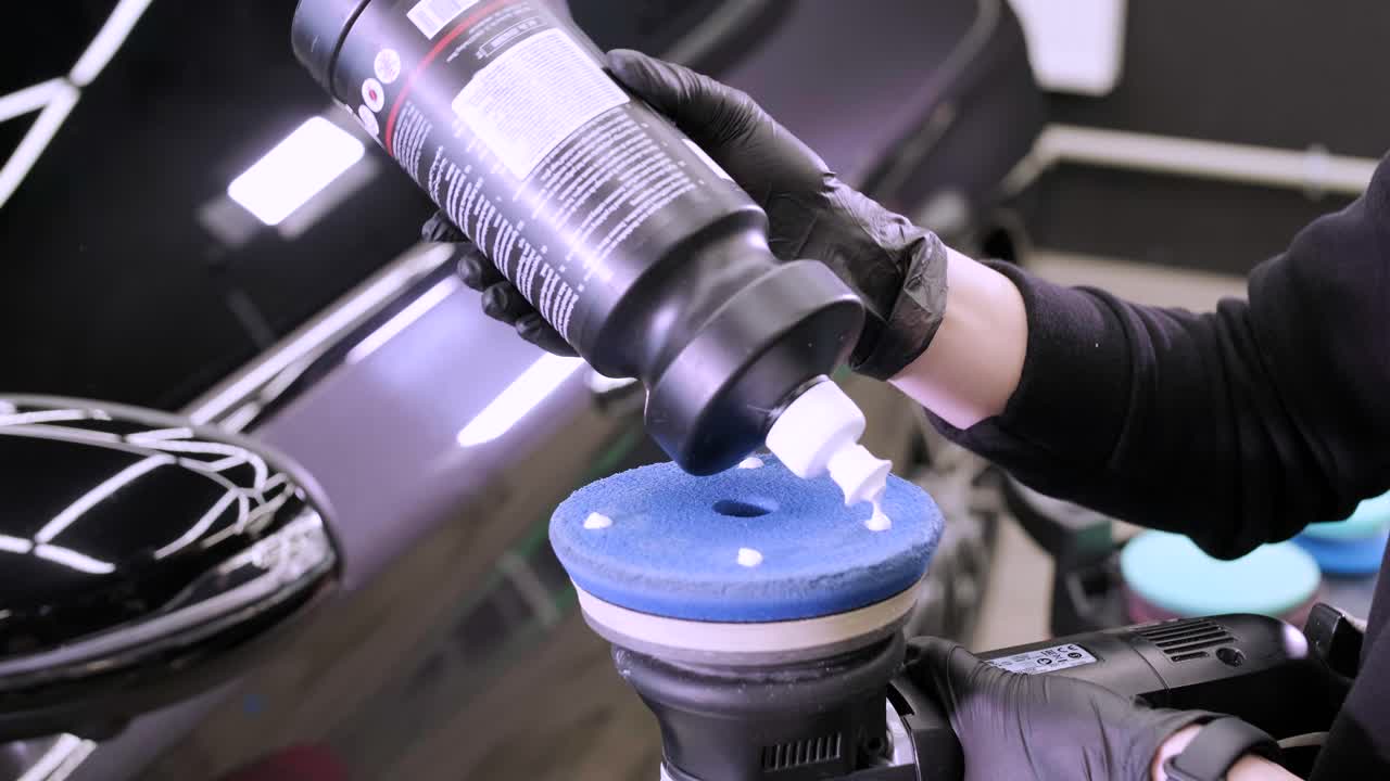 Professional car detailing using machinery and polishers for paint restoration.