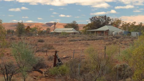 this video captures rustic buildings, a classic windmill, and the vast, arid australian landscape under a wide-open sky. perfect for conveying remote charm and heritage.
