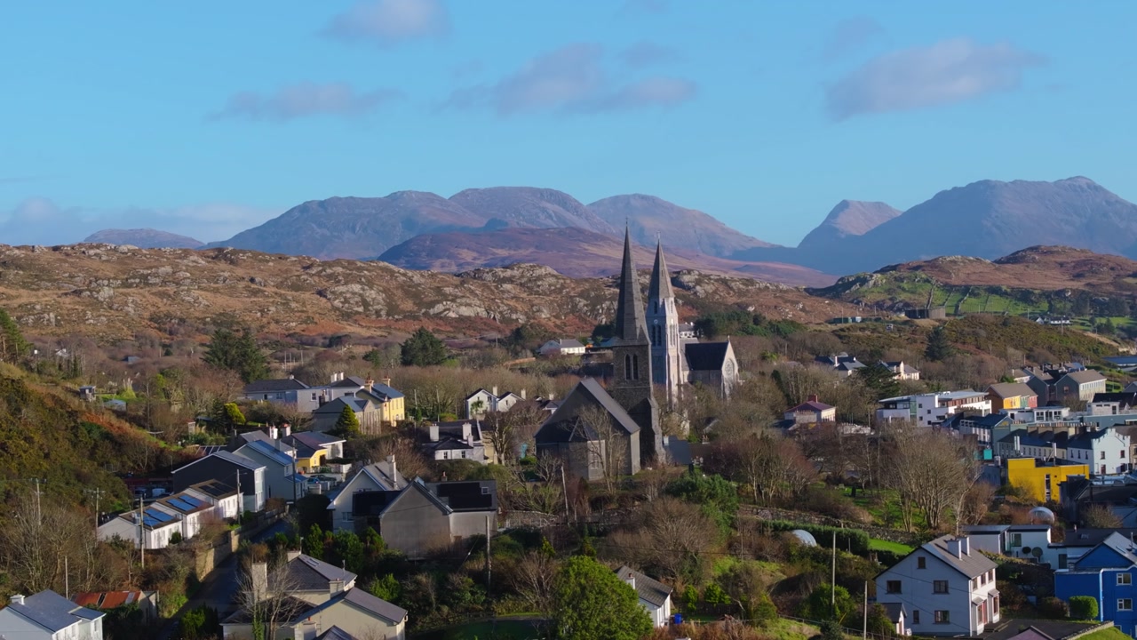 4K Aerial drone footage of St Joseph’s Church and Christ Church Clifden with Connemara Mountains Background_014