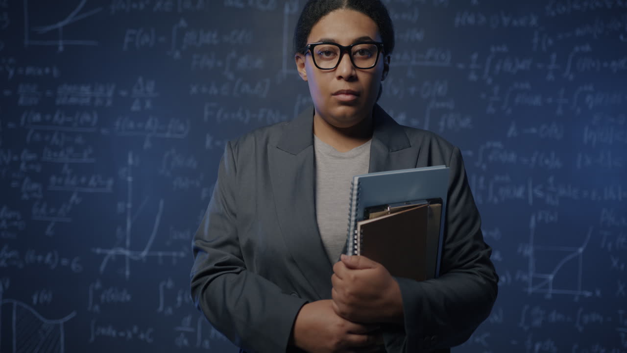 Woman in a classroom holding books