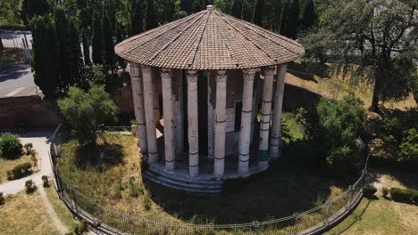 iconic circular roman temple with marble columns standing amid historic ruins