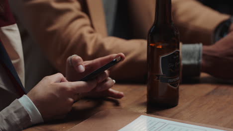 young woman using smartphone in restaurant texting on social media  sharing reunion party with friends having fun evening