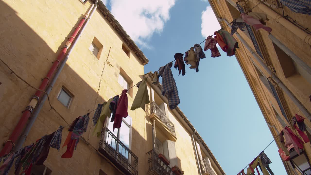 Drying Clothes Hanging Out To Dry Across The Typical Street In Montpellier, France