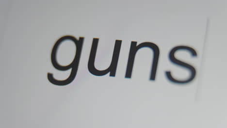 a close up of a digital screen showing a text cursor and "guns" being typed