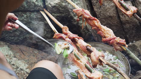 cooking meal on campfire over rocks in jungle