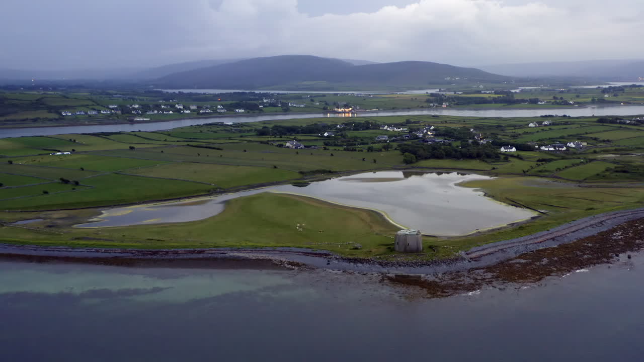 Aerial drone footage of Aughinish Island from sea with vast Clare landscape
