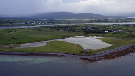 aerial drone footage of aughinish island from sea with vast clare landscape