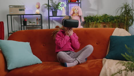 child kid girl using modern virtual reality futuristic technology vr app headset helmet to play game