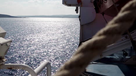 view of mediterranean sea from ferry, rope in foreground