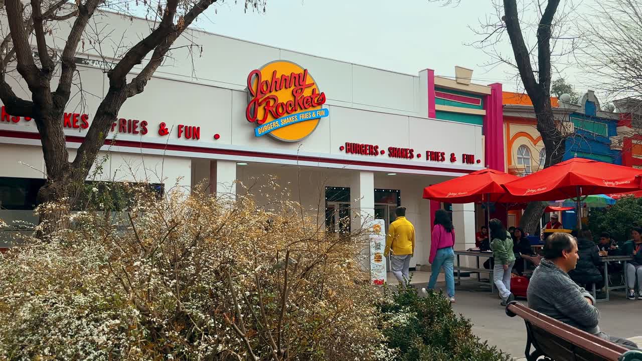 Establishing panoramic view of the Johnny Rockets thematic restaurant inside the Fantasilandia amusement park in Santiago, Chile.
