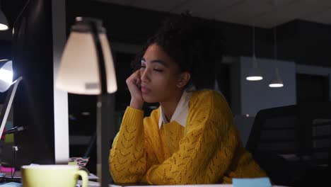 Tired-businesswoman-working-on-laptop-in-a-modern-office