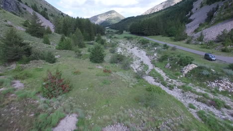 Flying-next-to-the-road-over-the-creek-at-the-beautiful-Col-du-Noyer