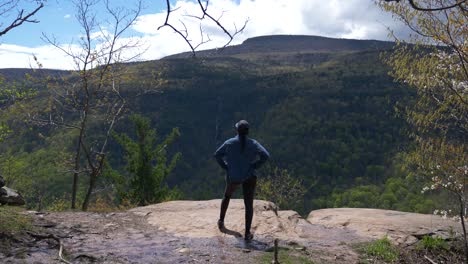 Strong-powerful-young-woman-confidently-looking-out-at-hiking-trail-viewpoint