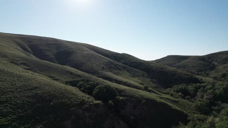 dramatic sloping mountain hills against bright blue sky in lemnos