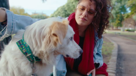 woman playing with dog on park bench
