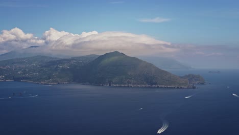 wide aerial view of the gulf of sorrento with fast clouds, blue sky and sea, from capri