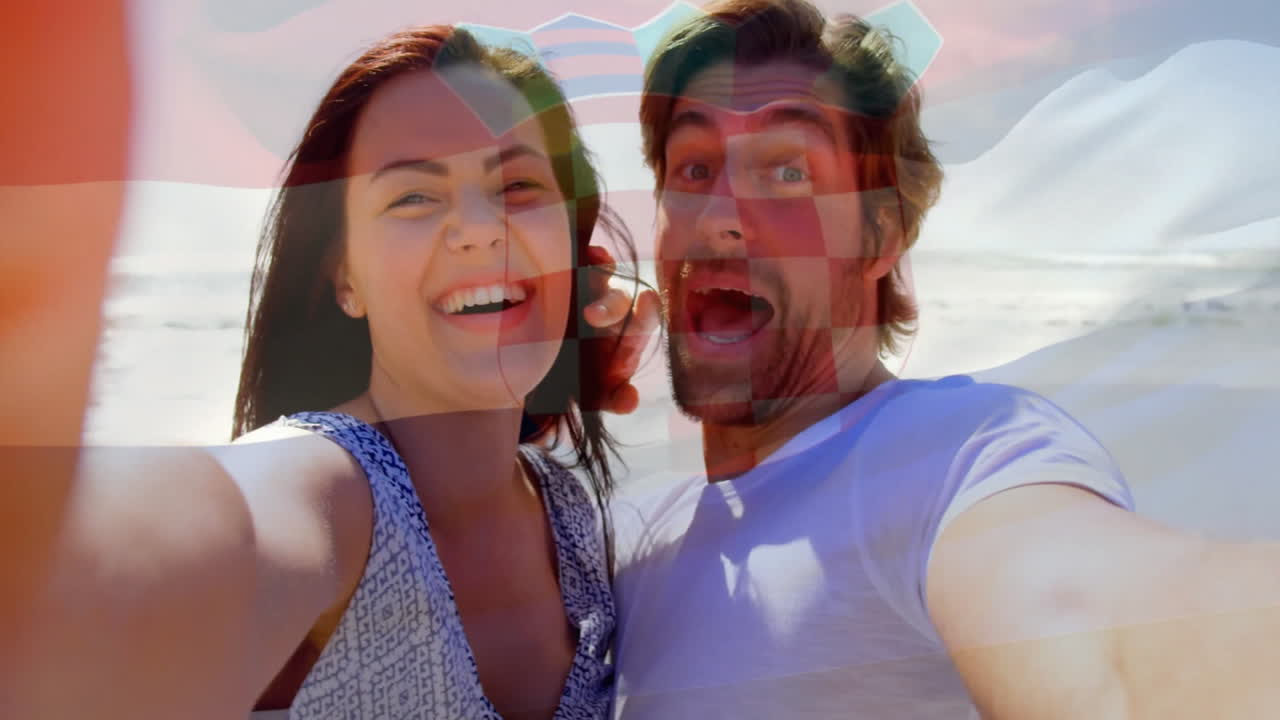At beach, couple taking selfie with animation of colorful shapes overlaying