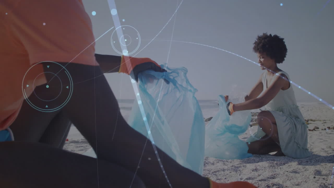 People collecting trash on beach with digital network animation overlay
