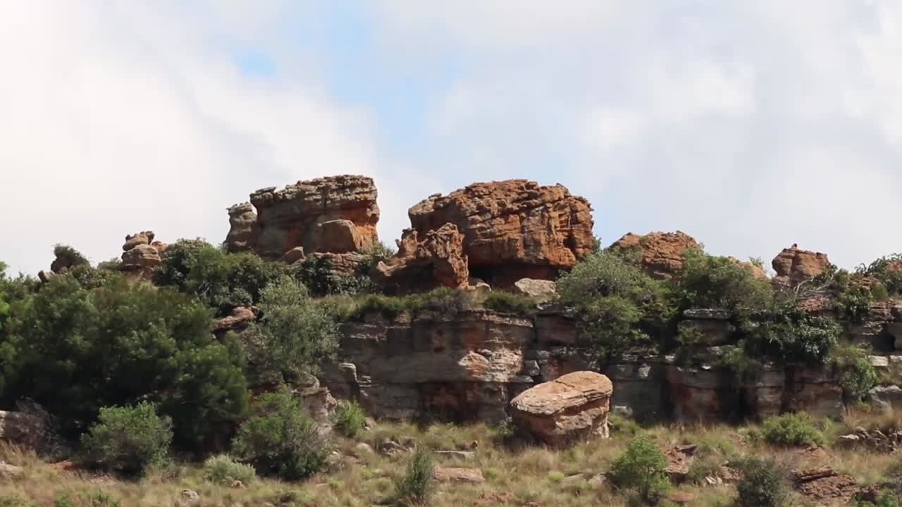 Large Rock formations on a hill on a warm day with heatwaves
