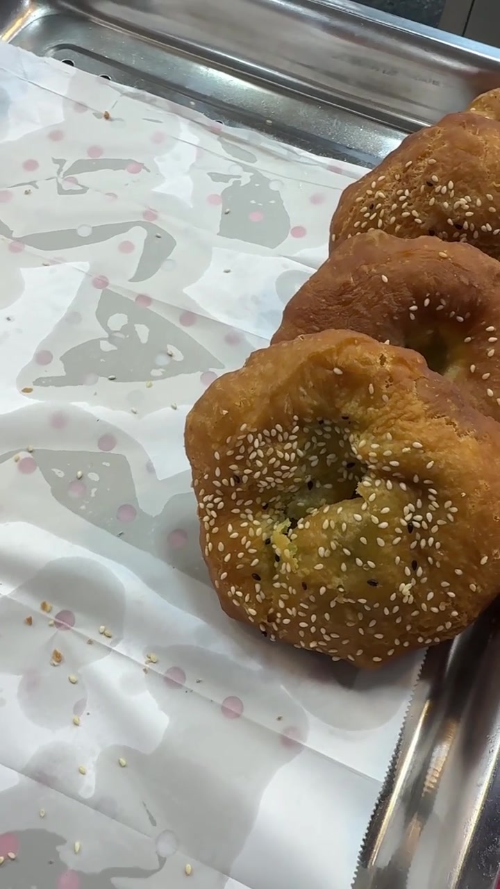 Freshly Fried Sesame Donuts on a Metal Tray