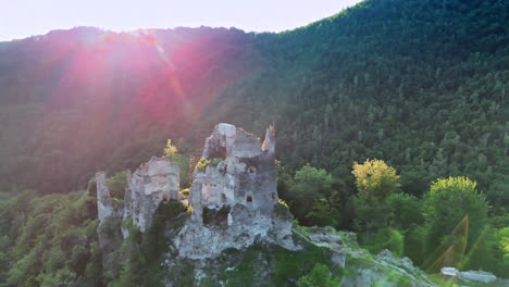 flying around the ruins of the old castle standing on the top of the rock. tatra mountains covered with woods surround the view