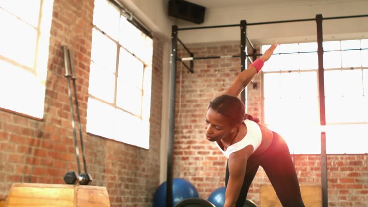 Fit woman exercising in crossfit gym
